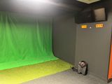 a green screen in the corner of a room