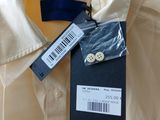 a label on a button down shirt on a hanger