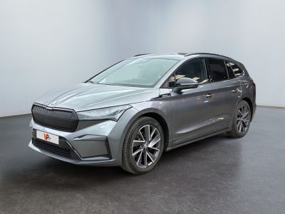 a grey car is parked in a large room with a black floor