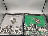 two t - shirts in a box on a table