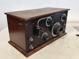 an old fashioned radio sitting on top of a wooden table