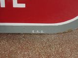 a close up of a stop sign on the ground
