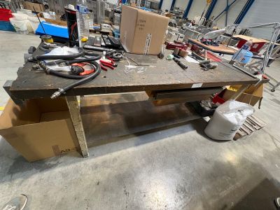 a workbench with tools on it in a warehouse