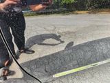 reflection of a person taking a picture of a skateboard in a car window