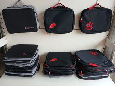 several pieces of luggage sitting on top of a shelf next to each other