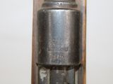 a close up of a metal object on a white surface