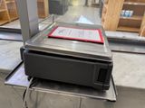 a printer sitting on top of a table in front of a window