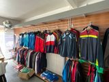 a lot of clothing hanging on the wall in the store
