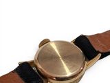a close up of a wrist watch on a white surface