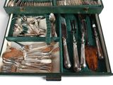 a green case with silverware in it on a white surface