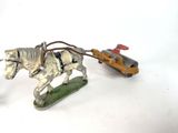 a toy horse pulling a sleigh with a man on it