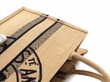 beige jute bag with black and white design on the front
