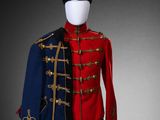 a red and blue military suit with gold trimmings on a mannequin mannequin