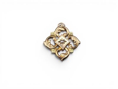a gold broochle with a cross on it