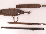 several different types of weapons are laid out on a white surface