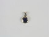a close up of a silver and blue stone pendant on a white surface