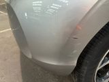 a close up of a car ' s front bumper with scratches on it
