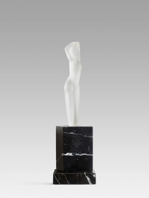 a statue of a woman standing on top of a marble block