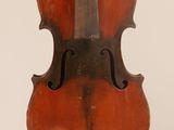 an old violin sitting on top of a white surface