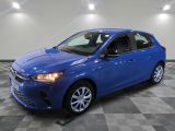 a blue car parked in a garage with a checkered floor