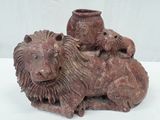 a statue of a lion and a lioness sitting on top of each other