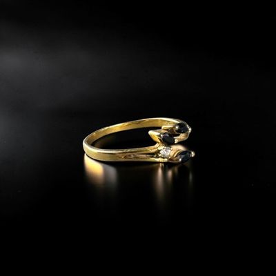 a close up of a gold ring on a black surface