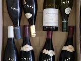 plusieurs bouteilles de vin dans une caisse sur la table