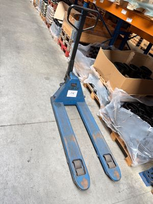 a forklift that is sitting on the floor in a warehouse