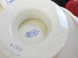 a close up of a white plate with a blue writing on it