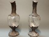 two vases that are sitting on a table