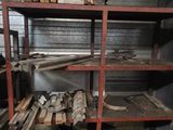 a metal shelf with a lot of wood on it