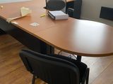 a desk with a chair and a laptop on it