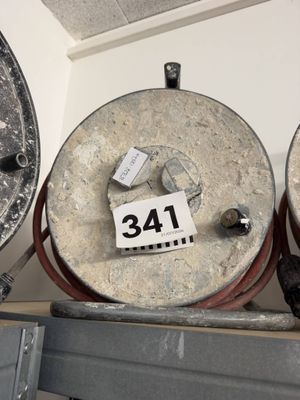 three old metal drums sitting on a shelf in a room