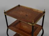 a three tiered table with a decorative design on it