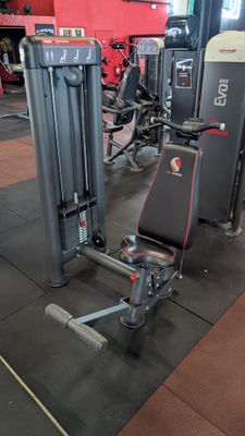 gym equipment in a gym with a red wall in the background
