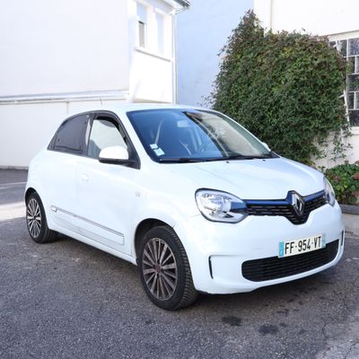 a picture of a white car parked in front of a house