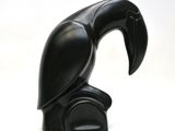 a black sculpture of a bird on a white background