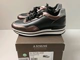 the shoe box has a pair of black and brown sneakers on it