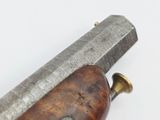 a close up of a knife with a wooden handle on a white surface