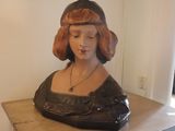 a bust of a woman sitting on a table