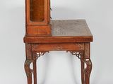 an old wooden table with a mirror on top of it