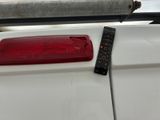 a remote control on the back of a white car