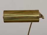 an antique brass plated lamp on a metal stand with a white background