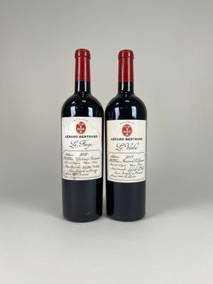 two bottles of red wine sitting next to each other on a table