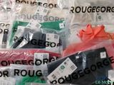many bags of clothes that are sitting on a table