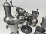 a lot of silver vases and cups on the table
