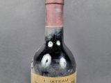 a bottle of red wine with two eyes painted on it