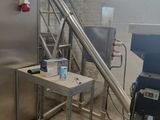 a large stainless steel refrigerator in a room with stairs