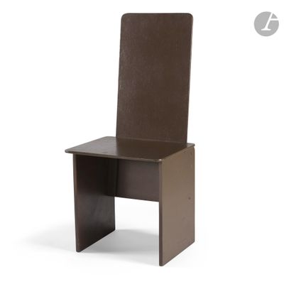 the chair is made of wood and has a brown leather seat