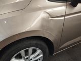 a car that has been dented and is parked in a garage